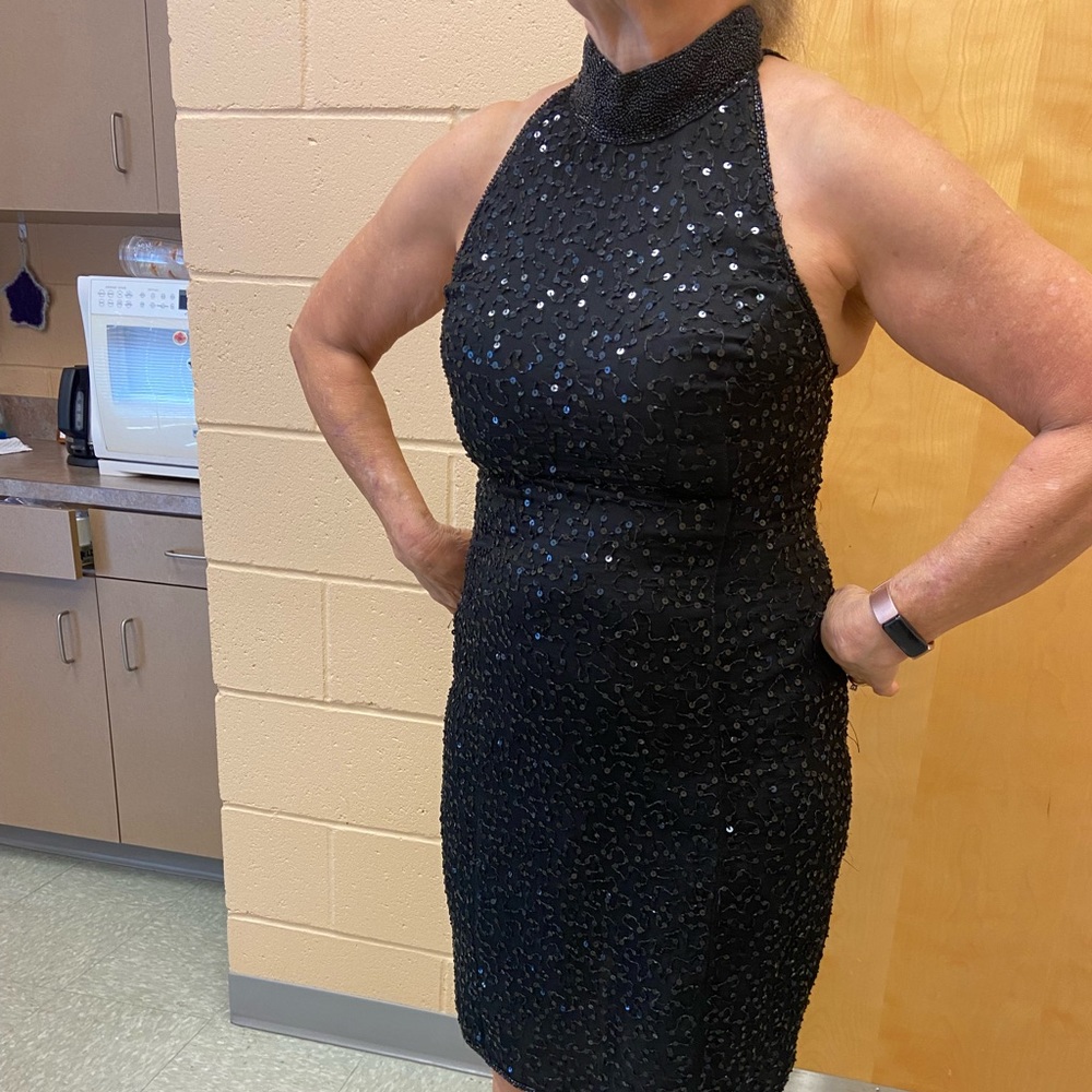 This Vintage dress is 100% Silk with a Polyester Lining.